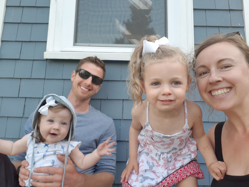 Portrait of Erica Riley, Hubbards Streetscape committee member, and family smiling in front of house.