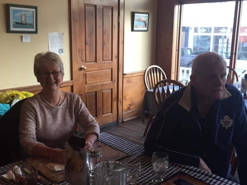 Janie Andrews, an older woman, is at a local restaurant smiling with an older man.