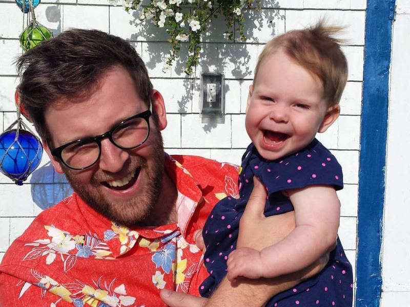 Matt Morash ,Hubbards Streetscape committee member, smiling with baby daughter outside.