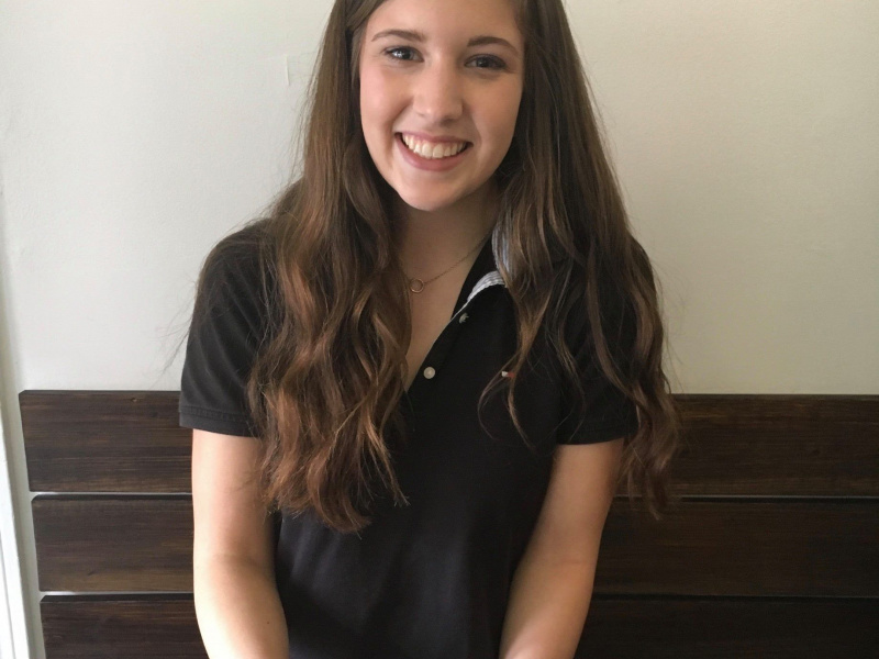 Sarah Doane, a young adult, enjoying a meal at a restaurant.