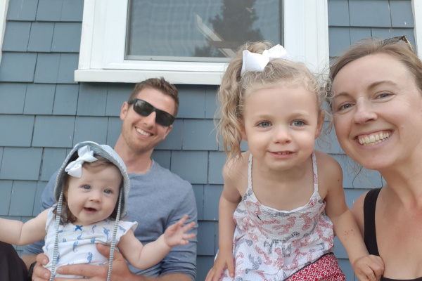 Portrait of Erica Riley, Hubbards Streetscape committee member, and family smiling in front of house.