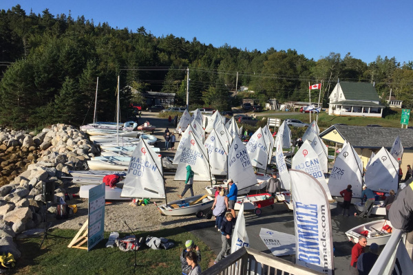 View of multiple Opti sail boats ready to make their way into the ocean at Hubbards Sailing Club.