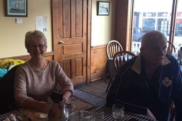 Janie Andrews, an older woman, is at a local restaurant smiling with an older man.
