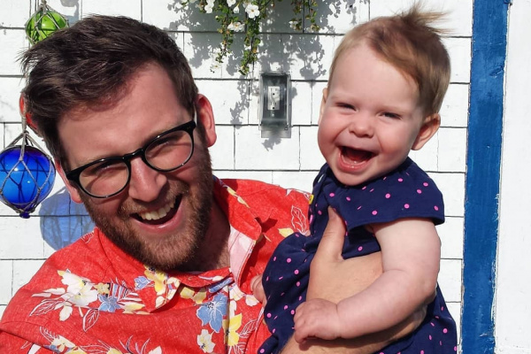 Matt Morash ,Hubbards Streetscape committee member, smiling with baby daughter outside.