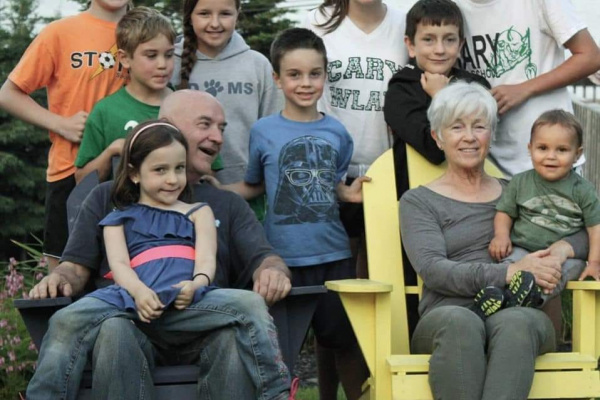 Pattrick Dunphy, a Hubbards resident, lovingly smiles at wife while surrounded by their nine grand children.